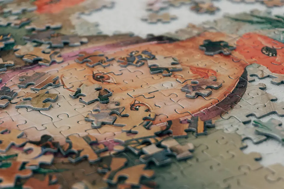 An incomplete jigsaw puzzle of a woman's face.