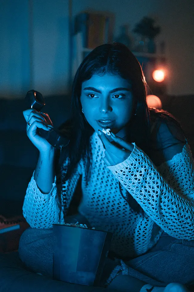 A woman watches television, before suddenly being overcome by anxiety.